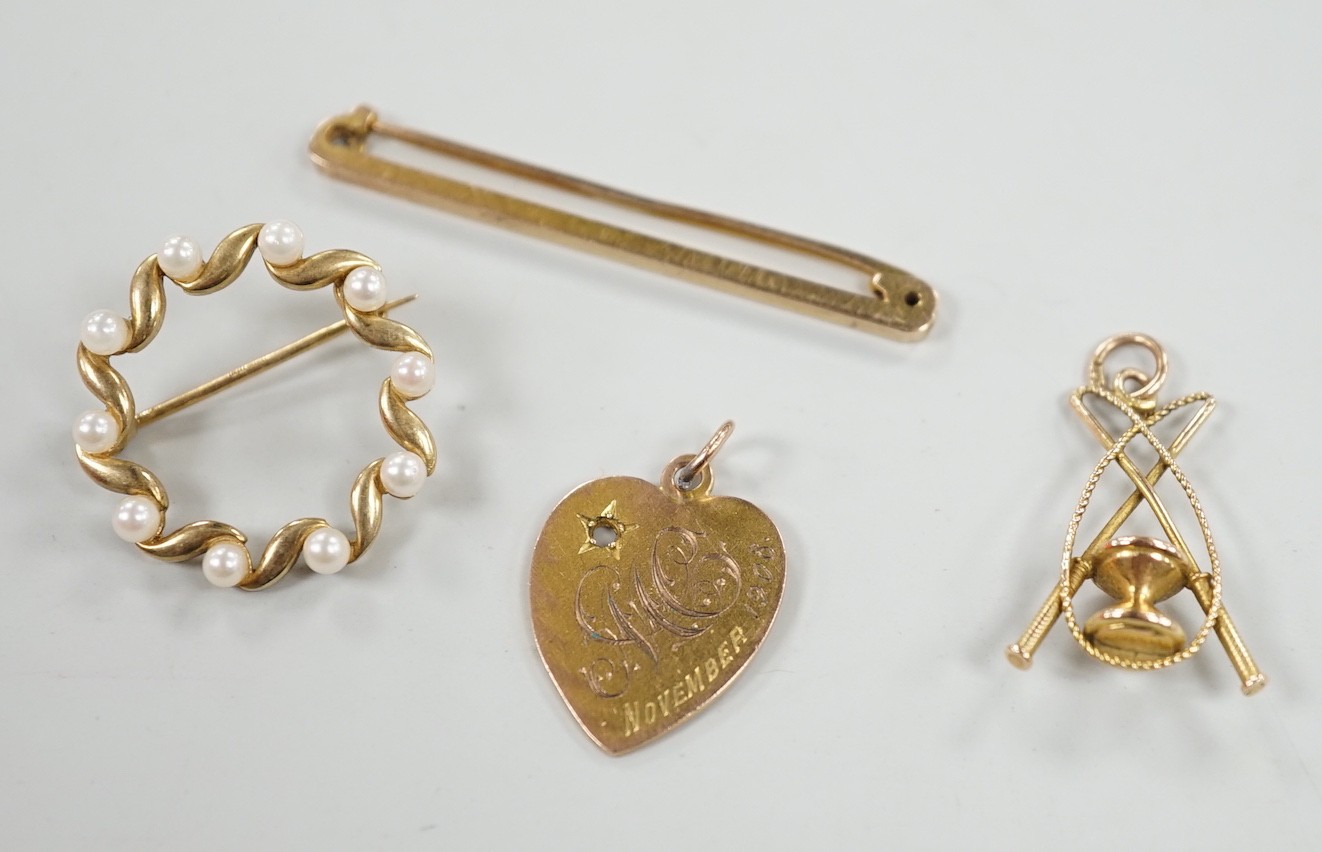 An Edwardian 9ct gold heart pendant (stone missing), 18mm, a yellow metal diablo charm and two brooches including 9ct bar brooch, gross weight 8.1 grams.